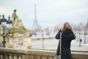 Tourist in Paris taking picture of the Eiffel tower